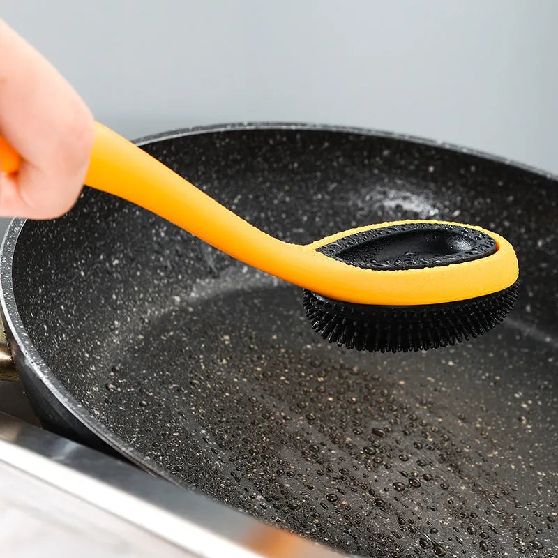 Yellow nonstick silicone and nylon cooking spoon and spatula set on a light background