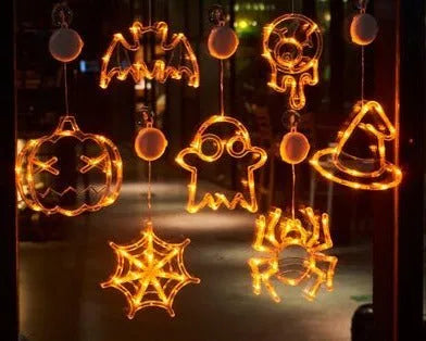 Seven Halloween LED window lights with spider, pumpkin and ghost designs on suction cups