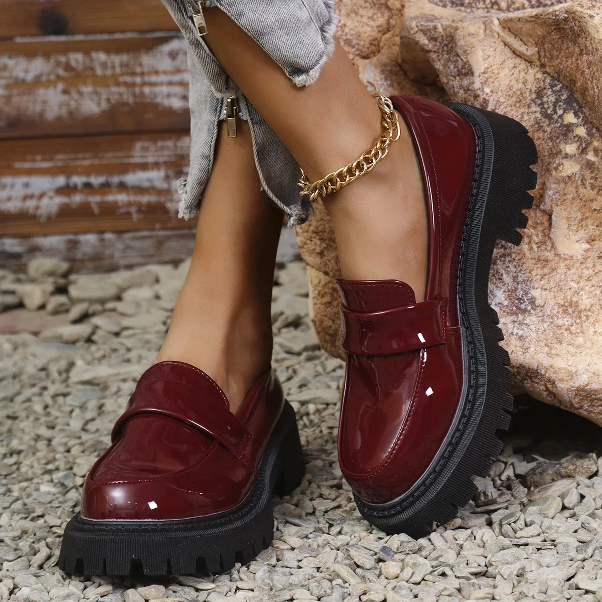 Women's black slip-on loafers with a chunky platform heel and rubber sole on a neutral background.