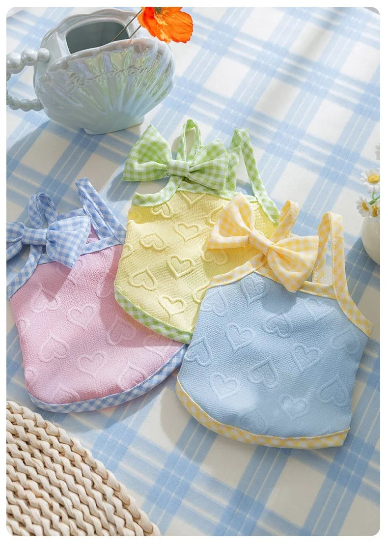 Small dog wearing heart relief texture bow suspenders vest in Bondi Blue colour with matching hairband