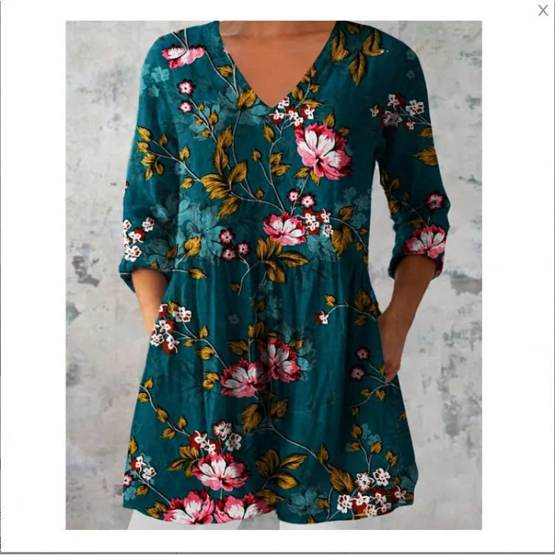 A woman wearing a loose-fitting printed dress with 3/4 sleeves and a wide waist.