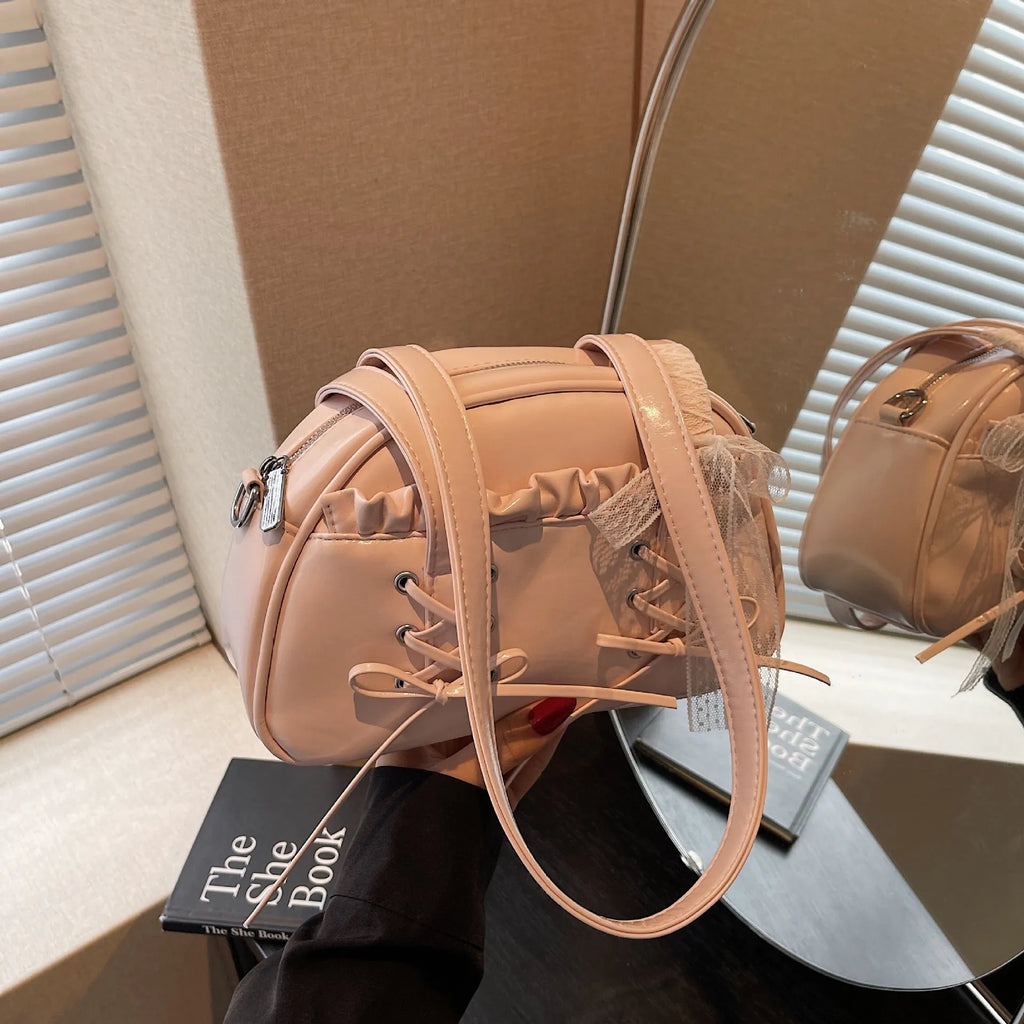 Ladies shoulder handbag with bandage bow design in PU leather showing phone pocket compartment