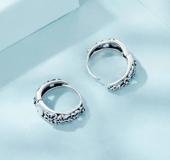 Retro hollow butterfly earrings in oxidised sterling silver with zircon stone accents on a white background.