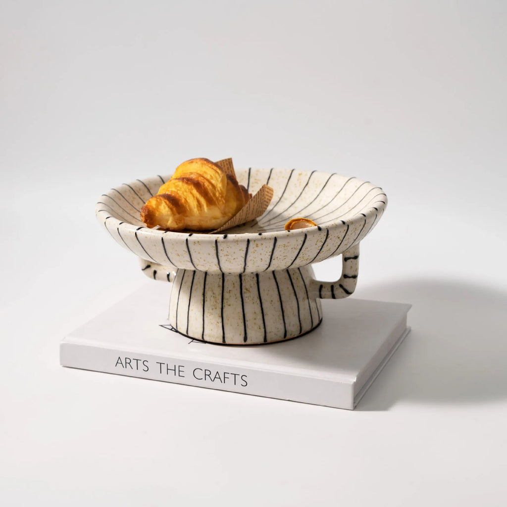 Black and white striped synthetic resin fruit plate or dessert plate on a table