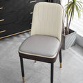 Leather horseshoe-shaped seat cushion in beige colour on a wooden chair, showing non-slip base