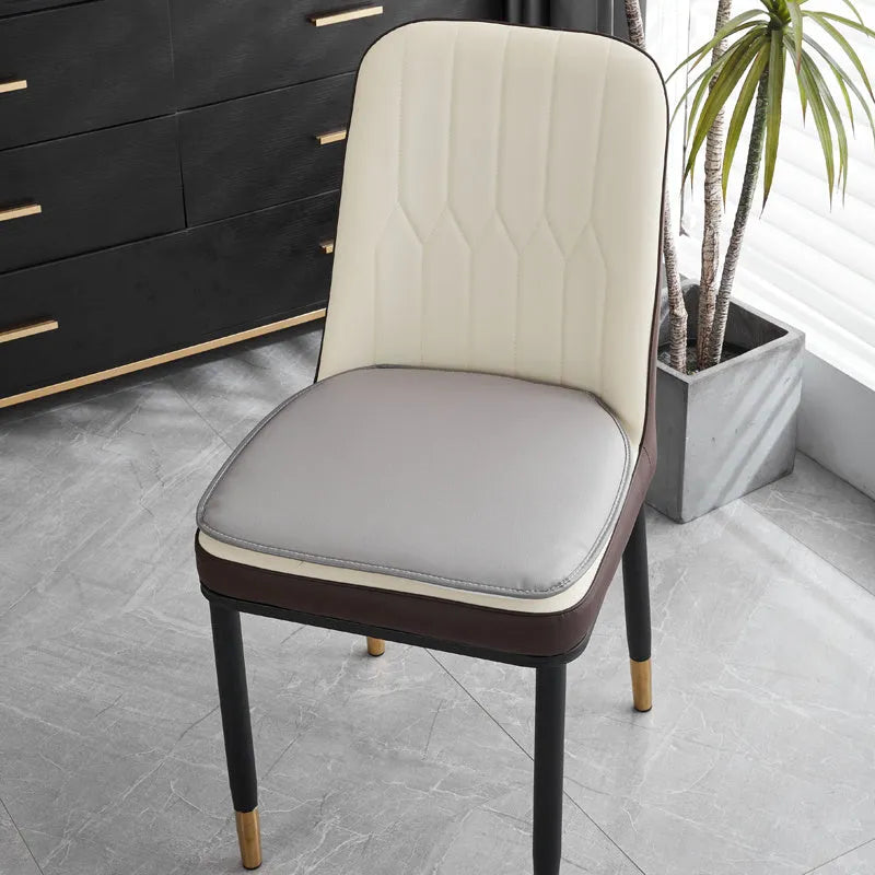 Leather horseshoe-shaped seat cushion in beige colour on a wooden chair, showing non-slip base