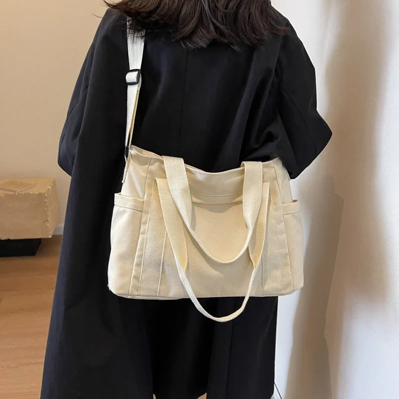 Polyester shoulder bag in solid colour with sandwich pocket and phone compartment