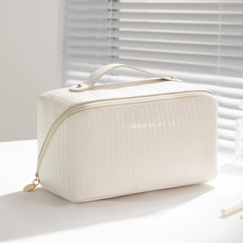 Beige cubic PU vertical pattern pillow makeup bag for travel, showing dimensions of 22.5cm by 12.5cm.