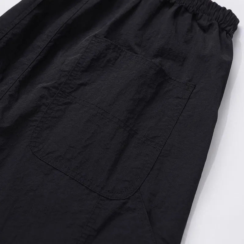 Black paratrooper trousers with elastic waistband and three-dimensional cutting in baggy fit style