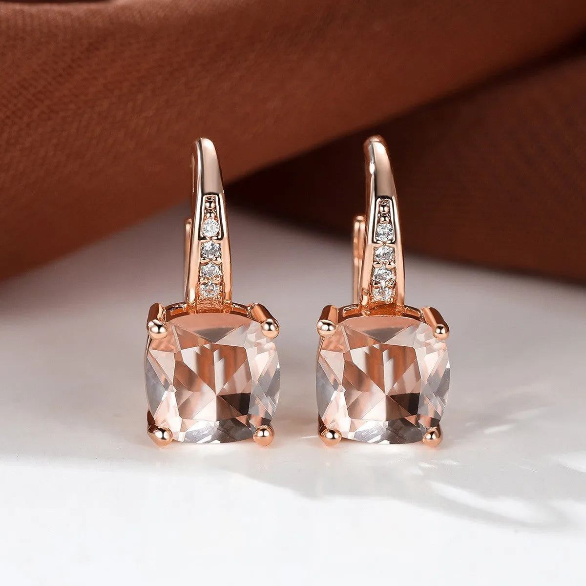 Square geometric ear hook studs with a round zircon stone, shown in a gold electroplated finish.