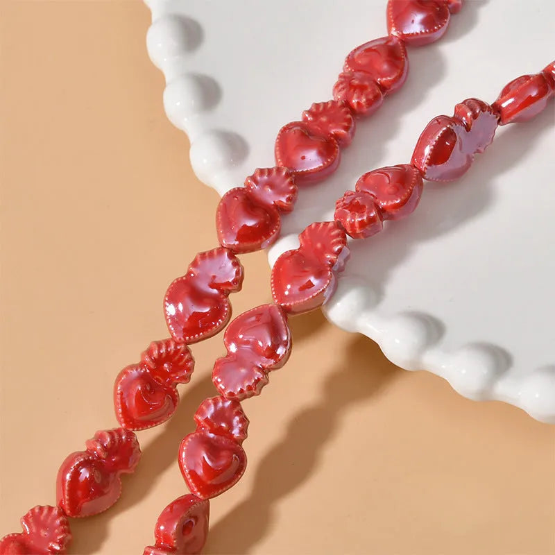 Ceramic heart torch beads in various colours for jewellery making, approximately 10mm by 15mm with straight hole