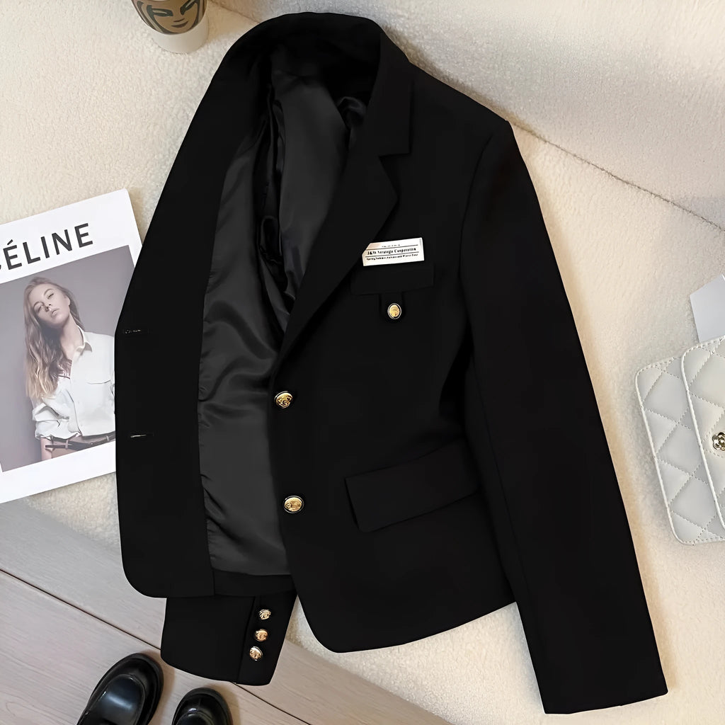 Black women's loose-fit short suit coat with long sleeves and pockets.