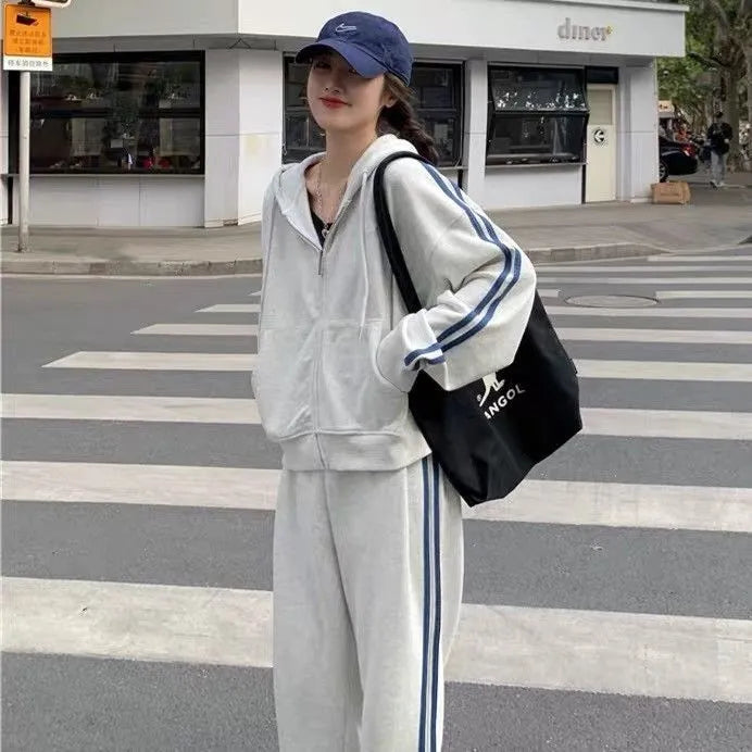 Striped polyester two-piece pants suit set for women in light gray or black with top and trousers coordinated