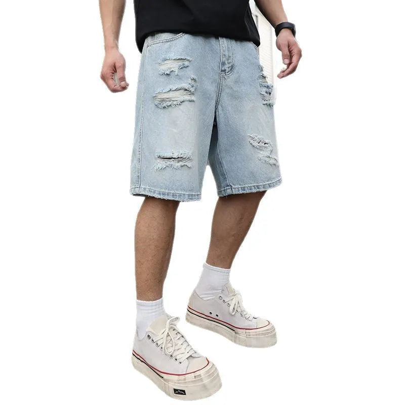 Light blue ripped denim shorts with a loose, straight-leg fit on a neutral background.