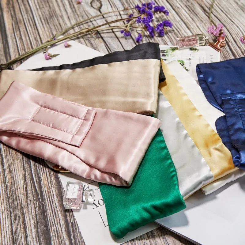 Mulberry silk sleep eye mask shown in multiple colours: black, gold, blue, grey, white, pink, and green.