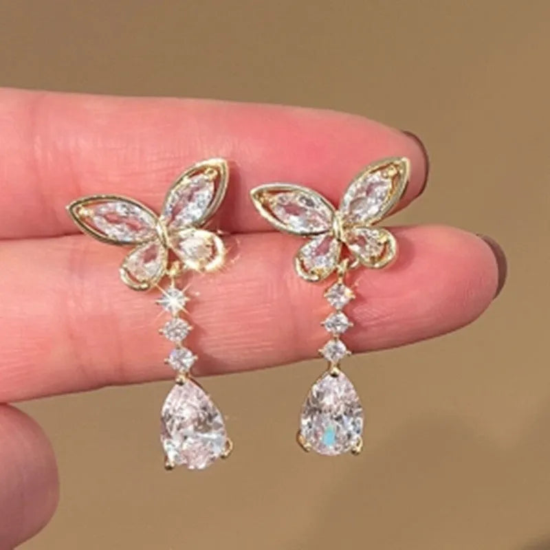 A pair of platinum-coloured bow-shaped stud earrings on a zinc alloy base.