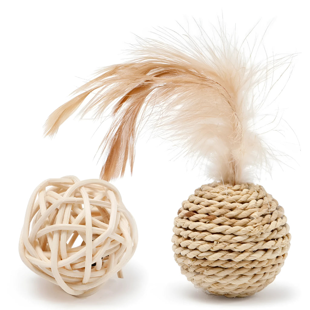 Two cat toys: a natural rattan ball and a colourful faux feather ball with a bell on a white background.