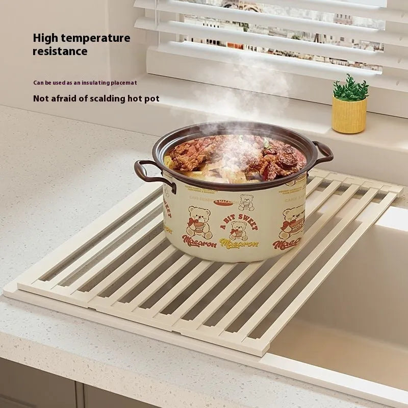 Milky white foldable stainless steel kitchen draining rack shown over a sink.