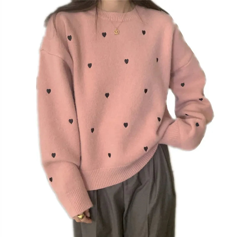 Women's loose-fit acrylic pullover sweater with embroidered heart detail on the front.