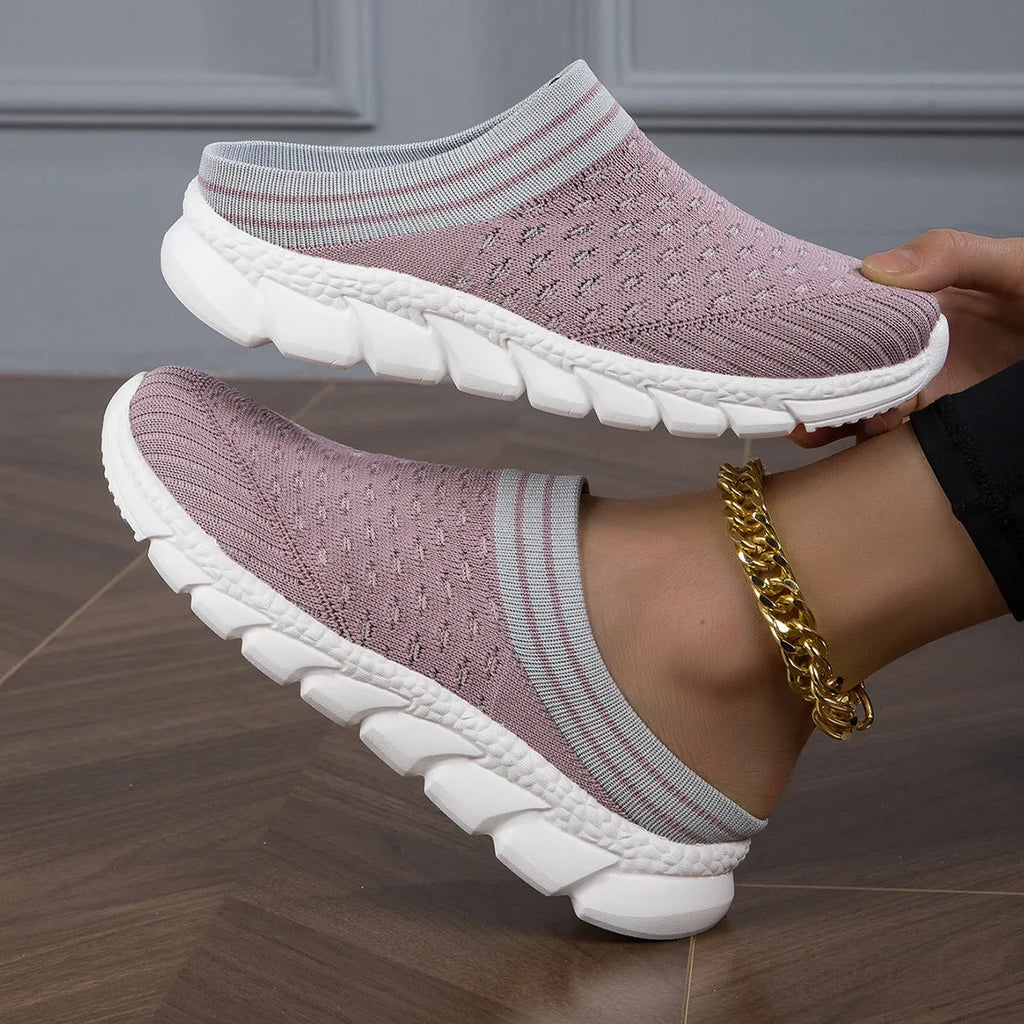 Women's black flyknit semi-slipper sock shoes with striped pattern and hollowed-out sewing lines on a lightweight sole.