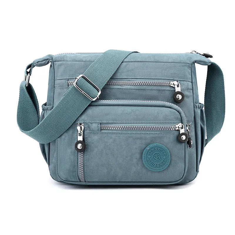 Soft nylon large capacity square messenger bag in multiple colour options on a single shoulder strap.