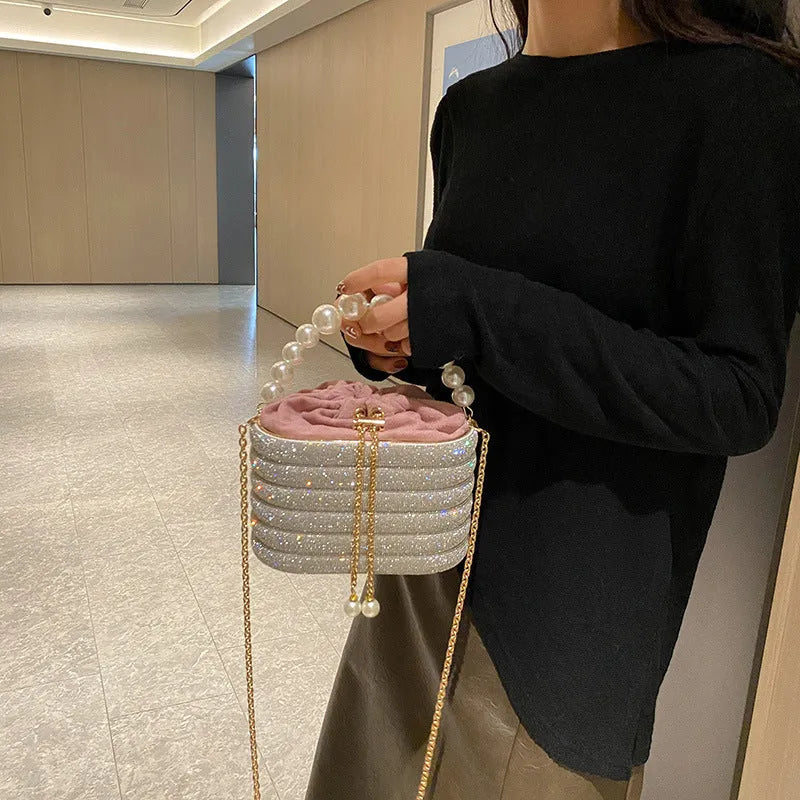 Retro style women's crossbody handbag with pearl beads in soft PU leather, shown in round shape.