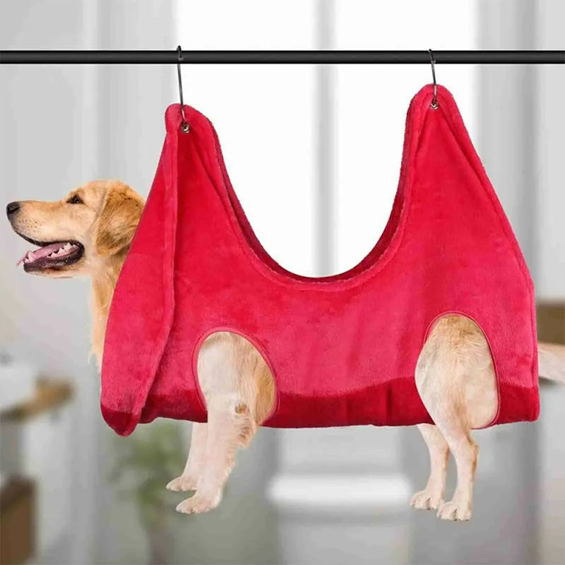Pet grooming hammock harness in pink with double-layer flannel fabric and reinforced grommets, showing a dog suspended comfortably