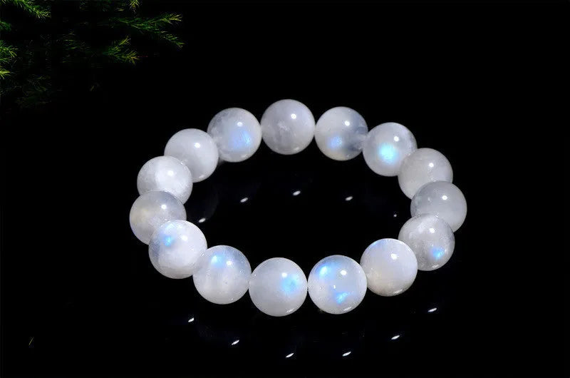 Natural blue moonlight round bead moonstone bracelet on wrist showing polished gemstone beads