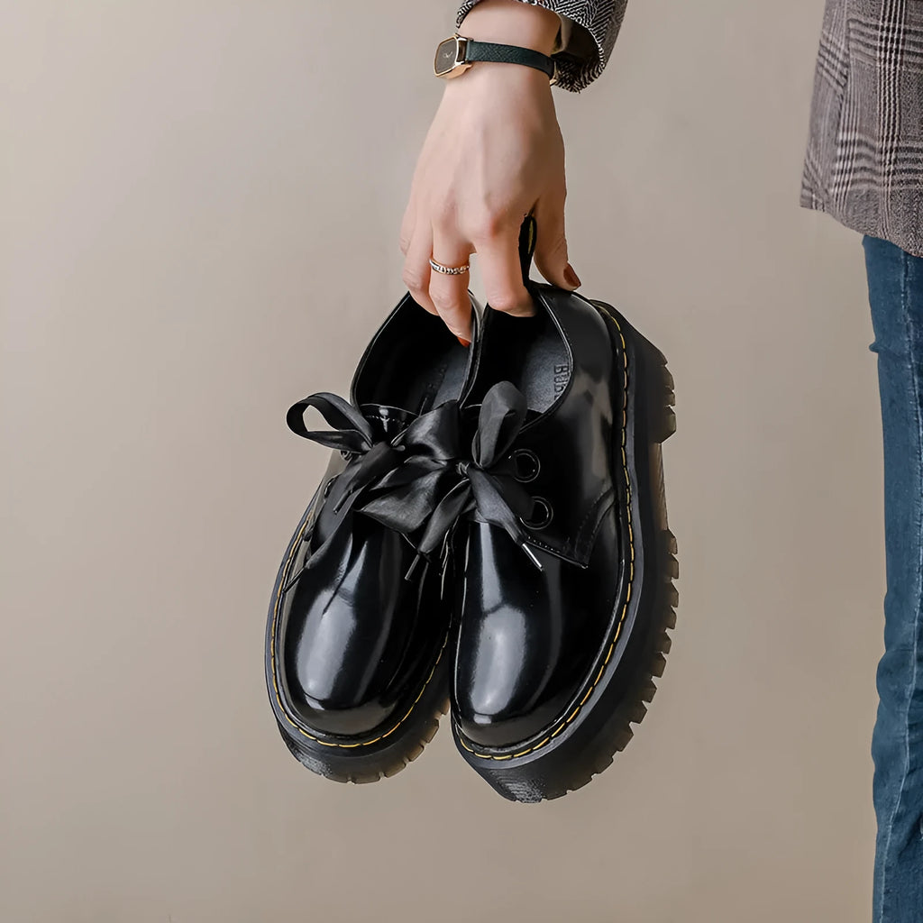 Women's black thick-soled leather shoes with cross straps and ribbon decoration