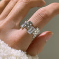 Silver geometric open ring with cross design and zircon decoration on white background