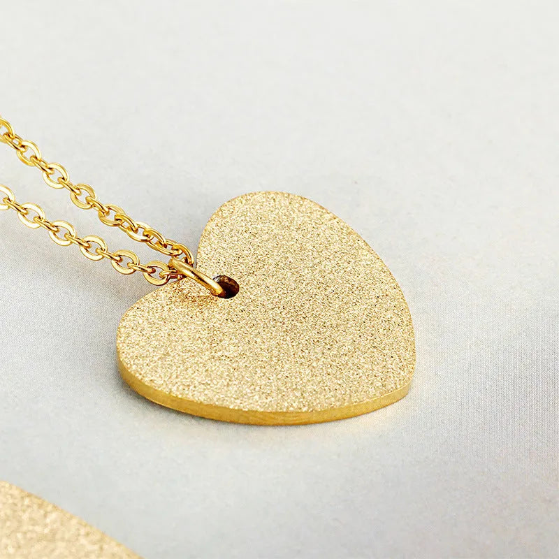 Geometric heart-shaped titanium steel pendant necklace on a model, colour KN25736-Z.