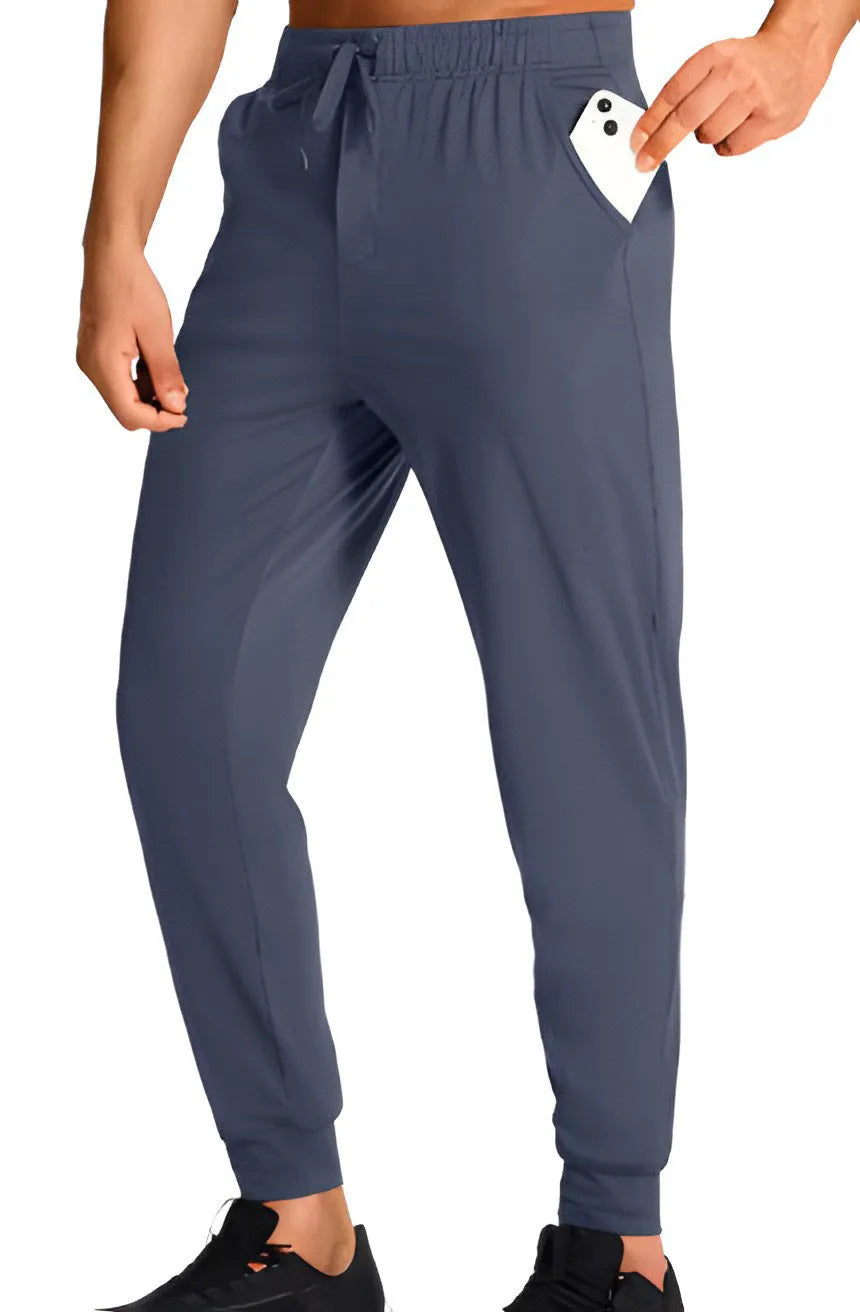 Men's loose-fit solid colour casual trousers made from polyester fabric on a hanger.