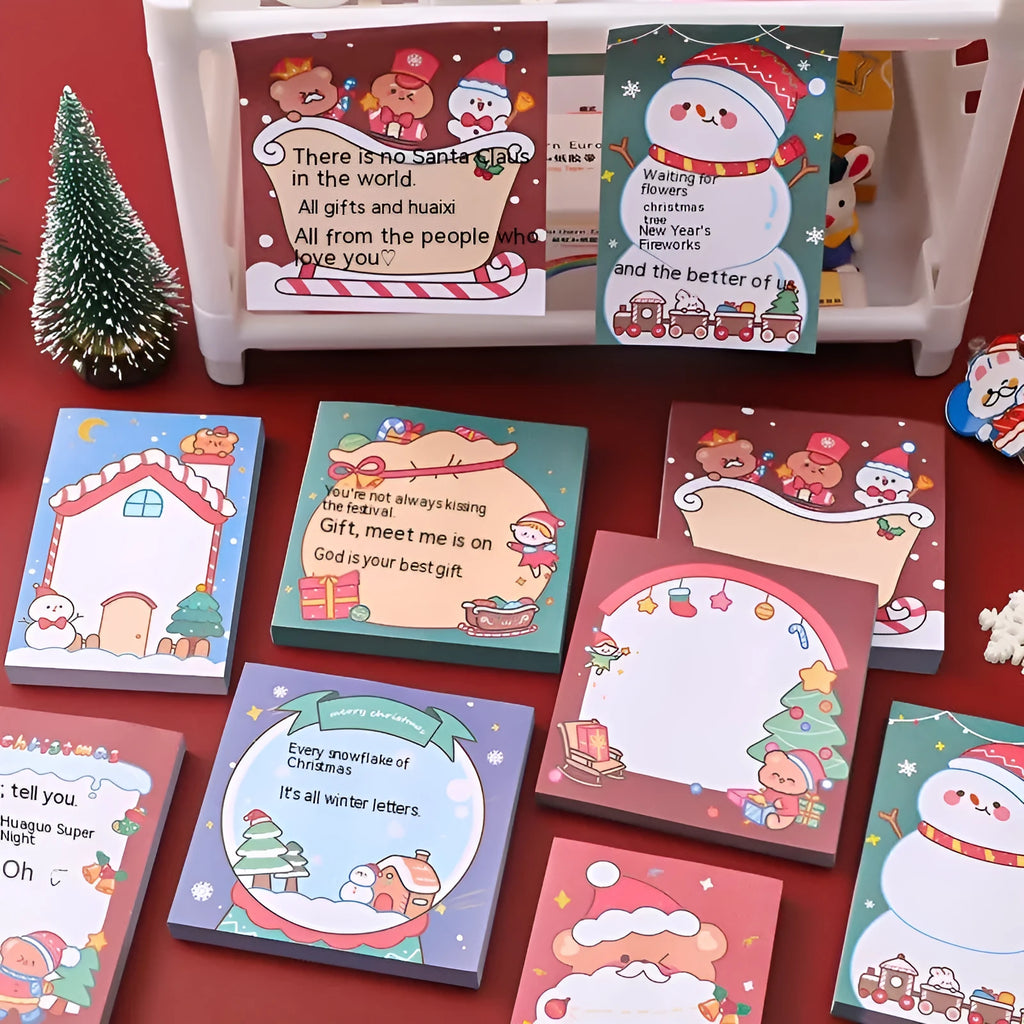 Christmas sticky notes pad with festive designs including elf, gift, sled, Santa Claus, bear, and snowman