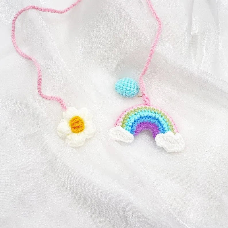 Handmade crocheted rainbow flower car pendant in wool with colourful avocado, pink, and red patterns