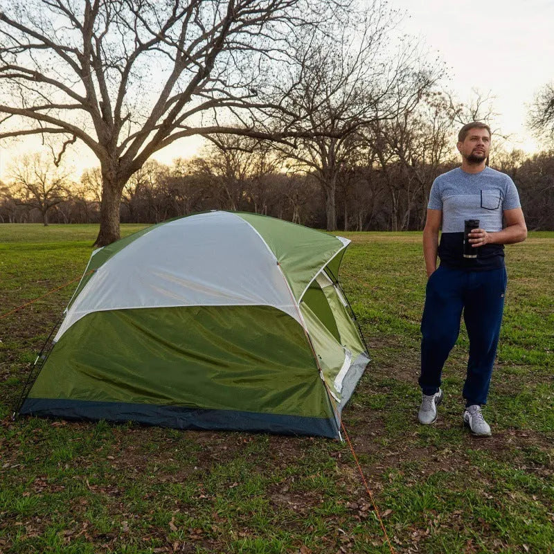 Orange portable 2-person camping tent with fibreglass poles set up outdoors