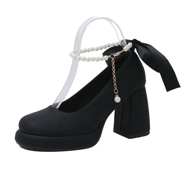 Women's beige Mary Jane shoes with a chunky heel, round toe, and a buckle fastening on the ankle strap.