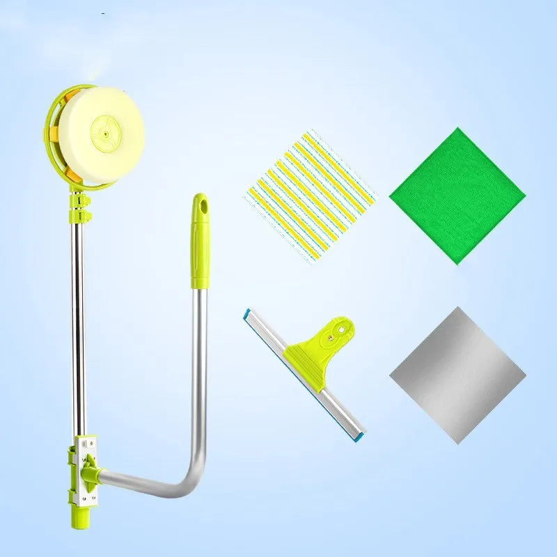 Green telescopic glass wiper with extendable handle resting on a windowsill