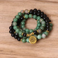 Green and black elastic beaded long bracelet with alloy components stretched on wrist