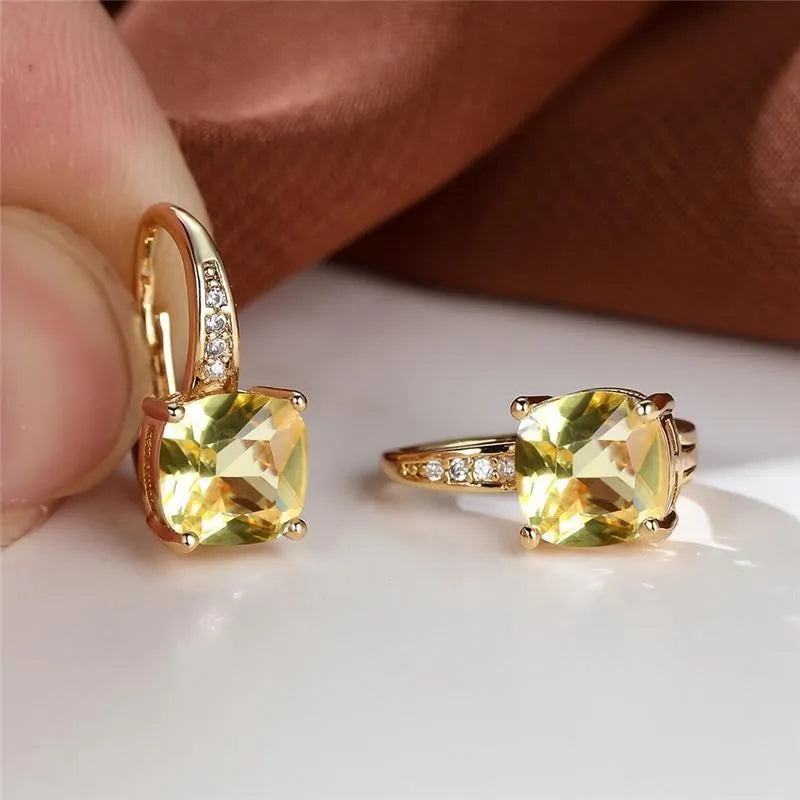 Square geometric ear hook studs with a round zircon stone, shown in a gold electroplated finish.
