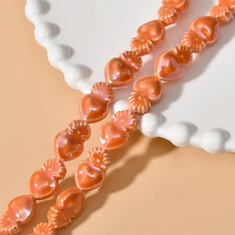 Ceramic heart torch beads in various colours for jewellery making, approximately 10mm by 15mm with straight hole
