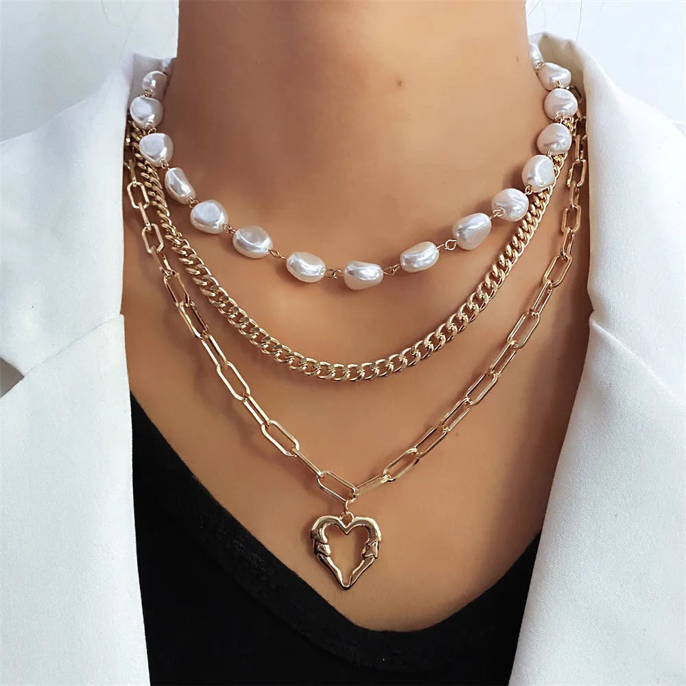 Vintage gold heart pendant necklace with pearl chain detailing showing adjustable length feature