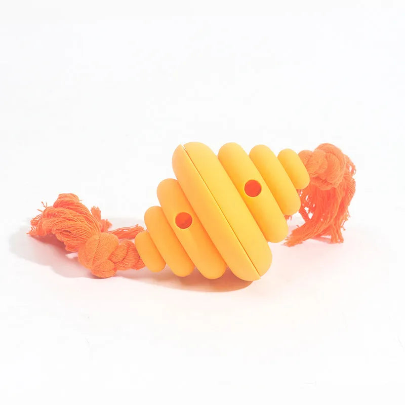 Green and yellow food-dispensing silicone dog ball with an attached rope for tug-of-war.