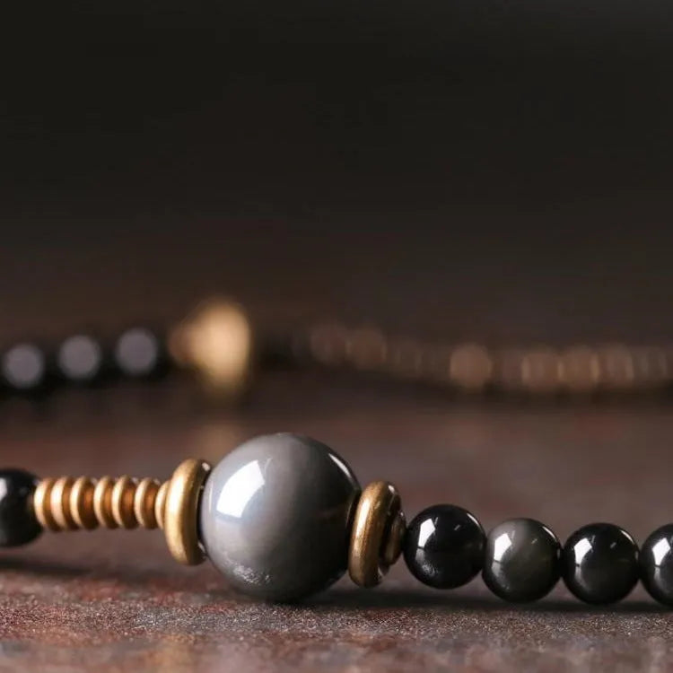 Black multi-layered beaded bracelet with geometric shapes showing natural style design