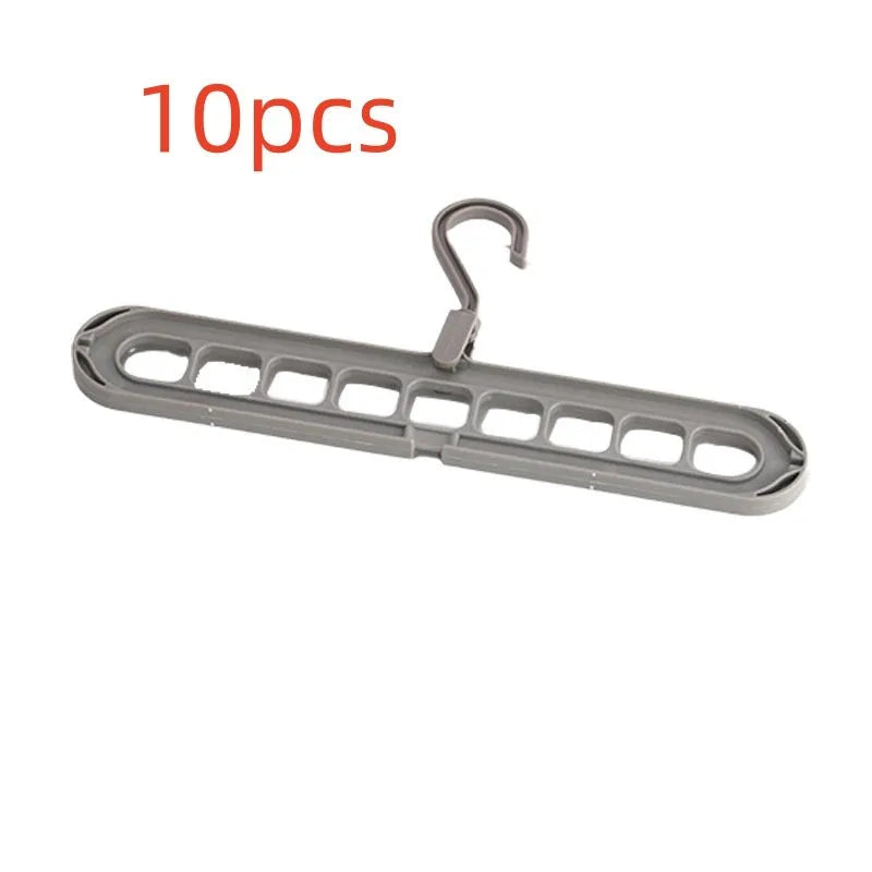 Green plastic nine-hole folding hanger for trousers displayed open and folded flat.
