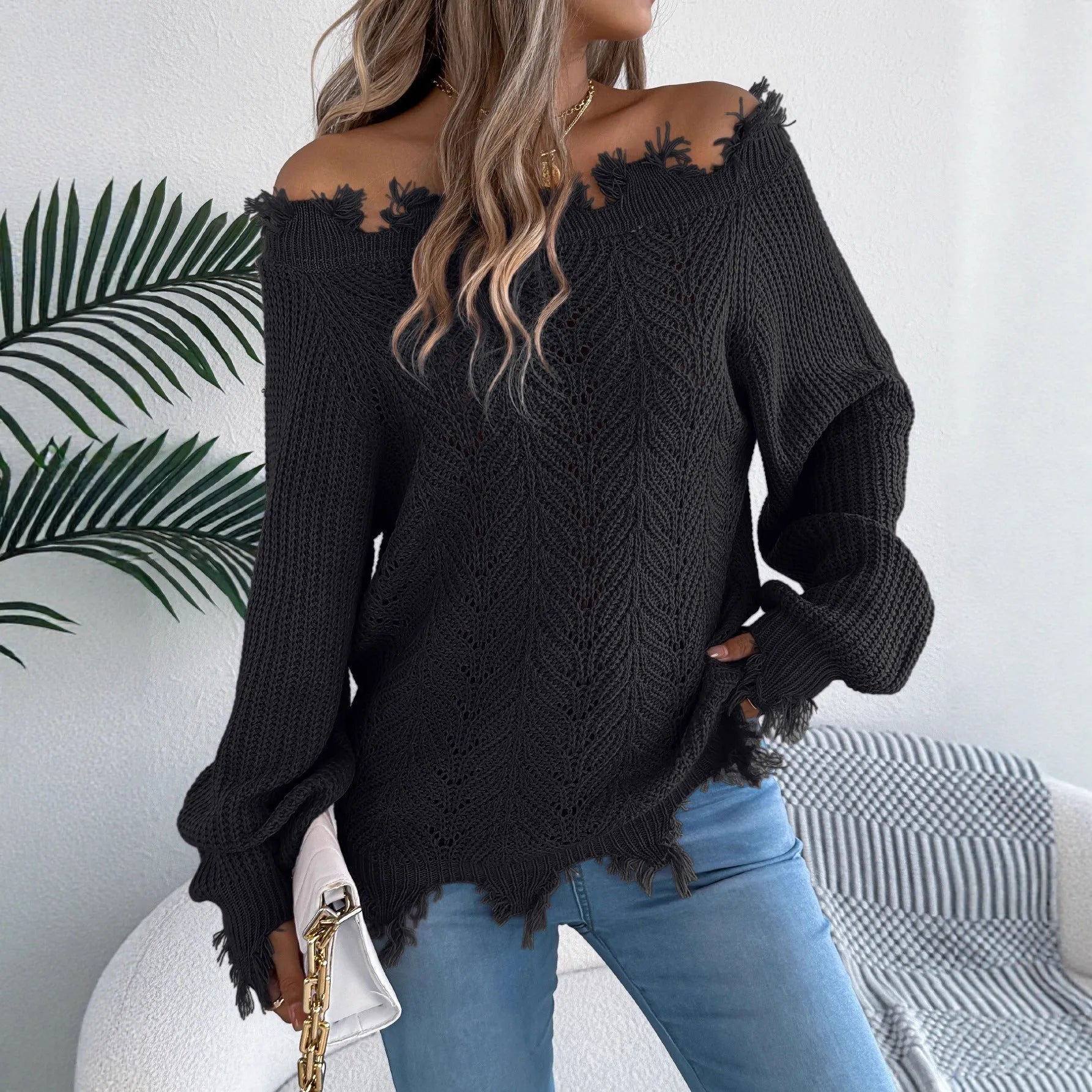 White hollow-out cut off shoulder pullover sweater with long sleeves on hanger