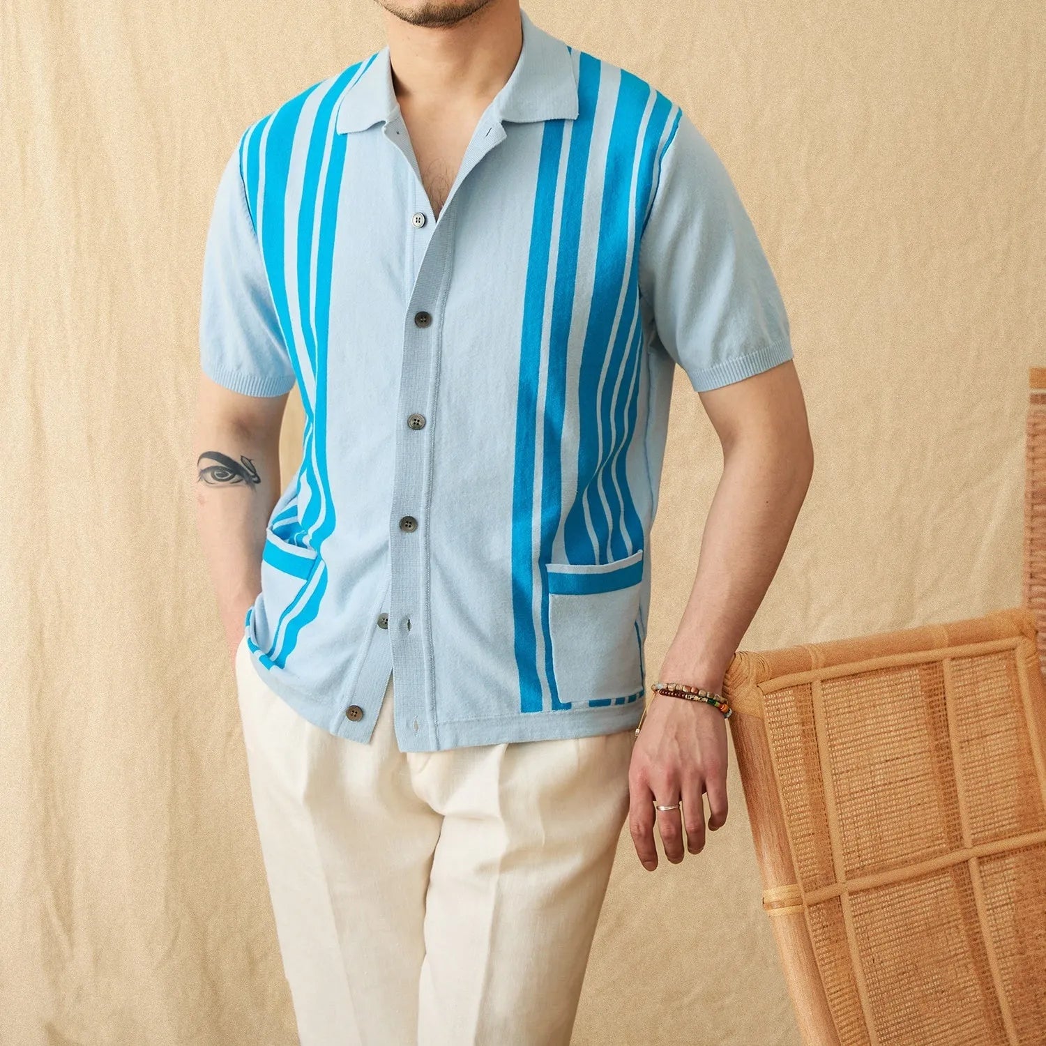 A man's short-sleeved striped cardigan polo shirt with a lapel collar, shown in a light blue colour.