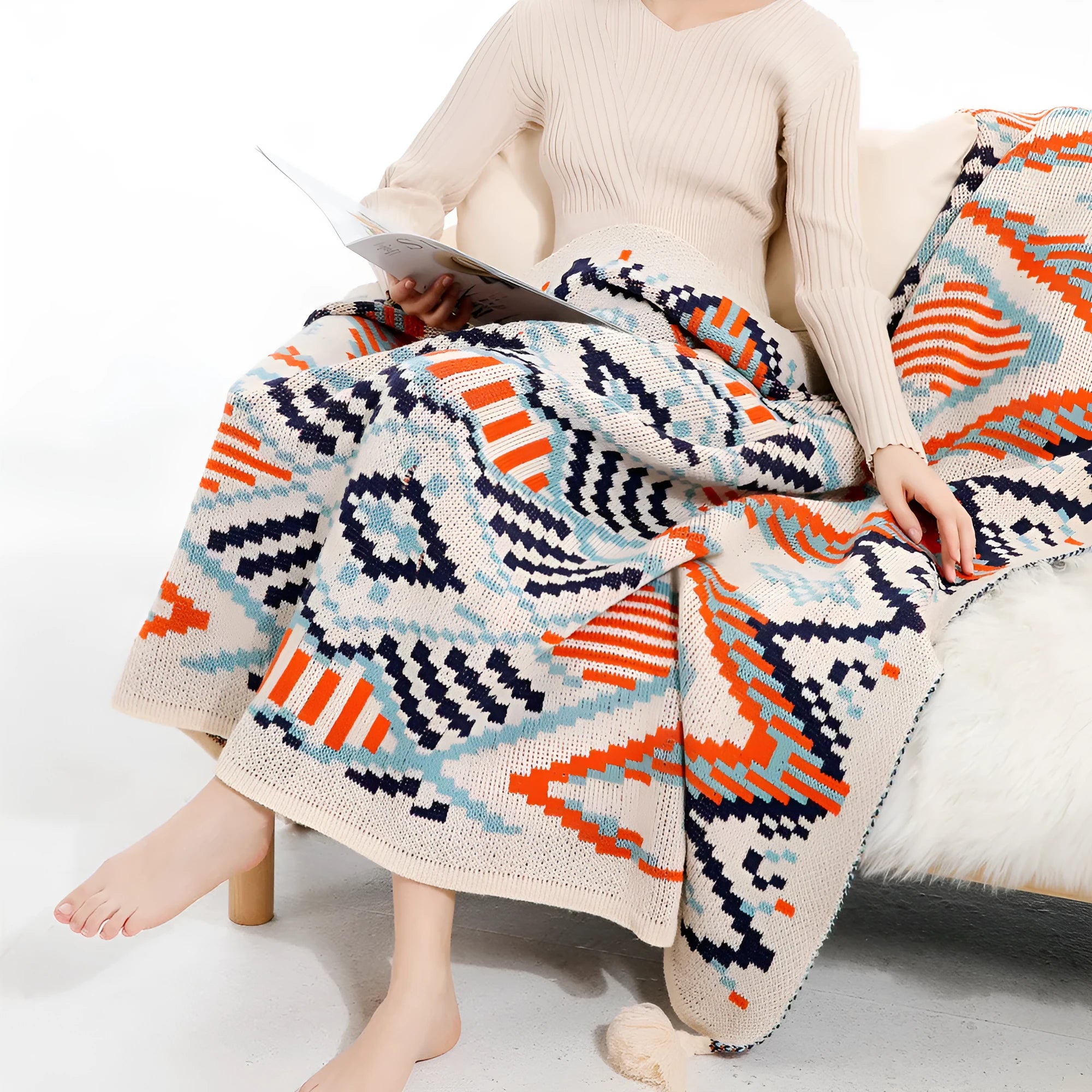 Acrylic sofa blanket with tassel fringe in geometric pattern, showing 130 cm width measurement
