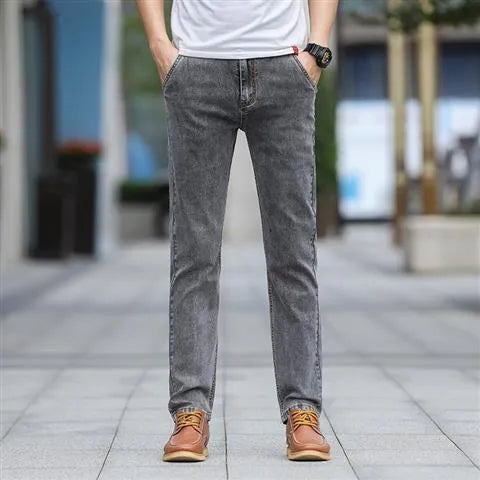 Men's smoky gray straight tube jeans with low waist and zipper fly closure