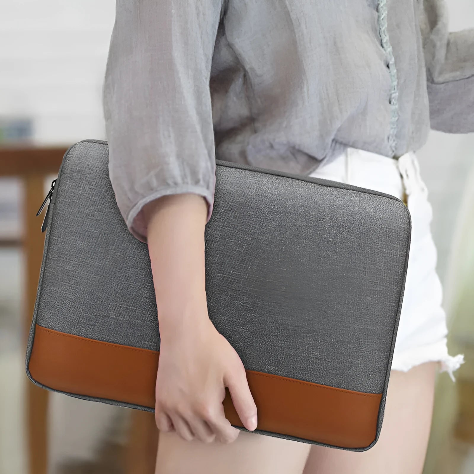13-inch Oxford cloth tablet PC liner bag in grey with zip closure on a flat surface
