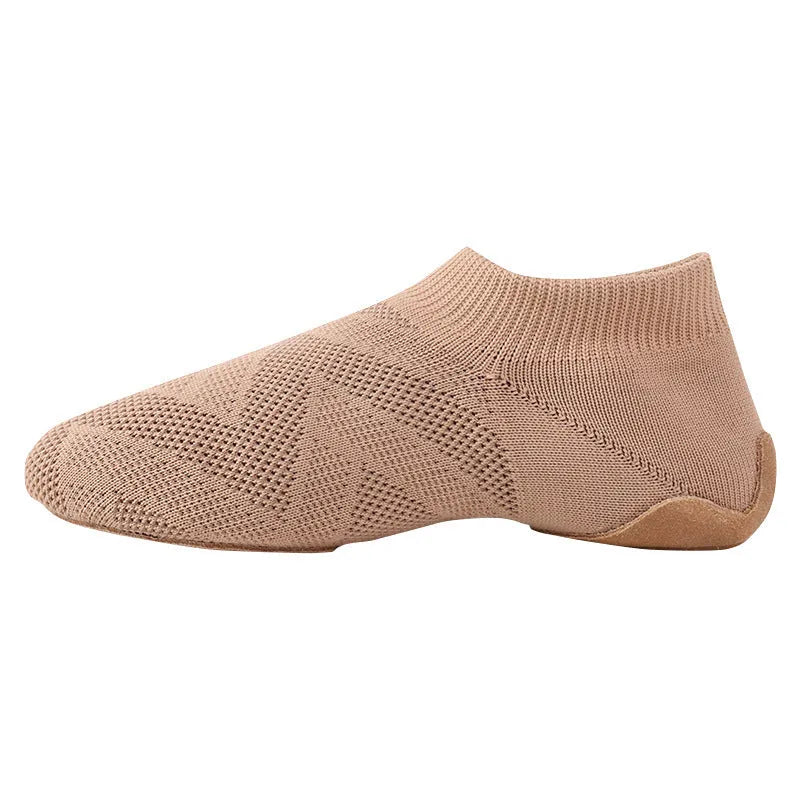 Camel coloured Latin dance shoes with cotton mesh upper and leather sole on a plain background.